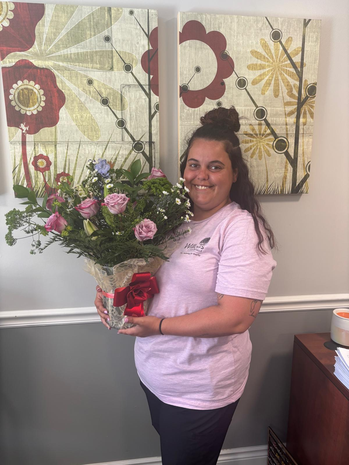 Blossomlife customer holding a handcrafted flower arrangement