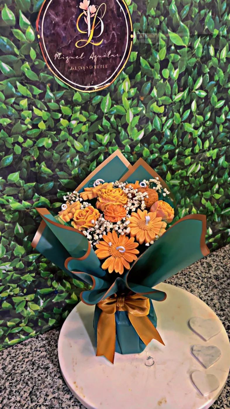 White and gold wrapped bouquet of yellow everlasting flowers