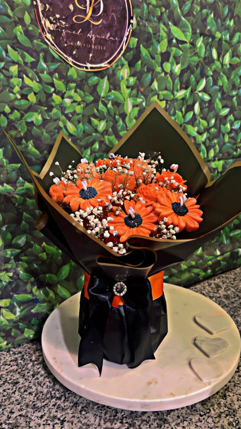 Teal wrapped bouquet of orange everlasting blooms
