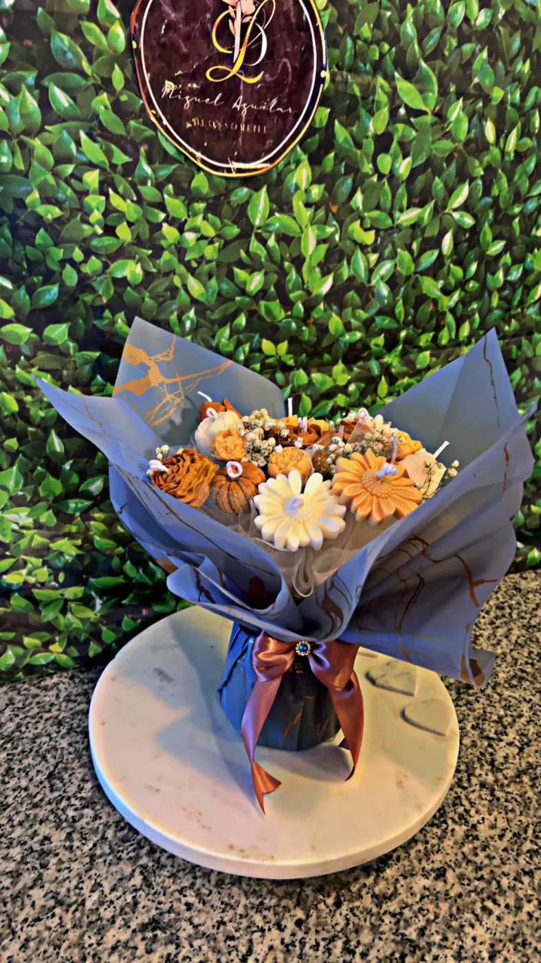 Black wrapped bouquet of orange everlasting flowers