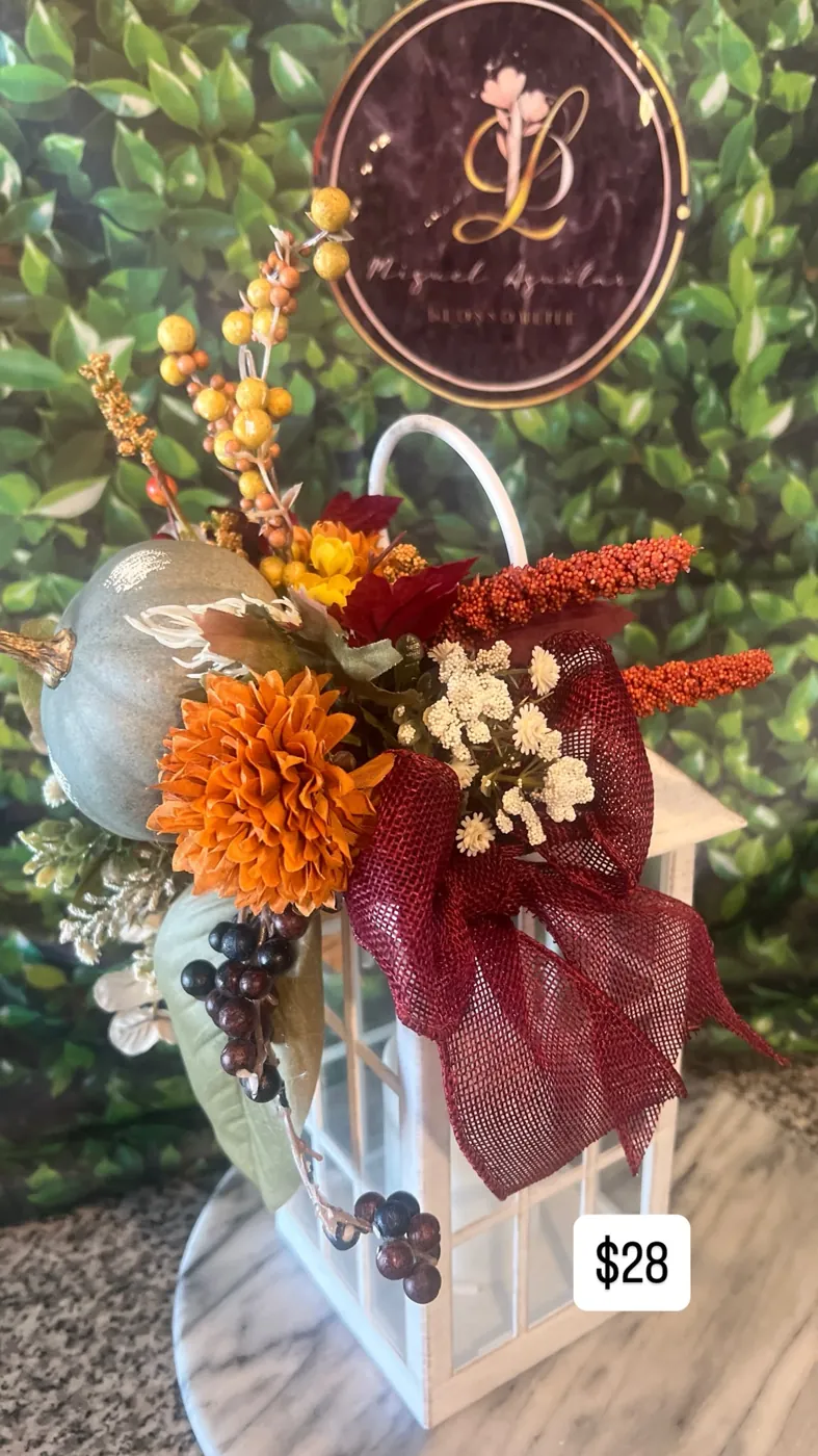 Red holiday wreath with poinsettias and a velvet bow