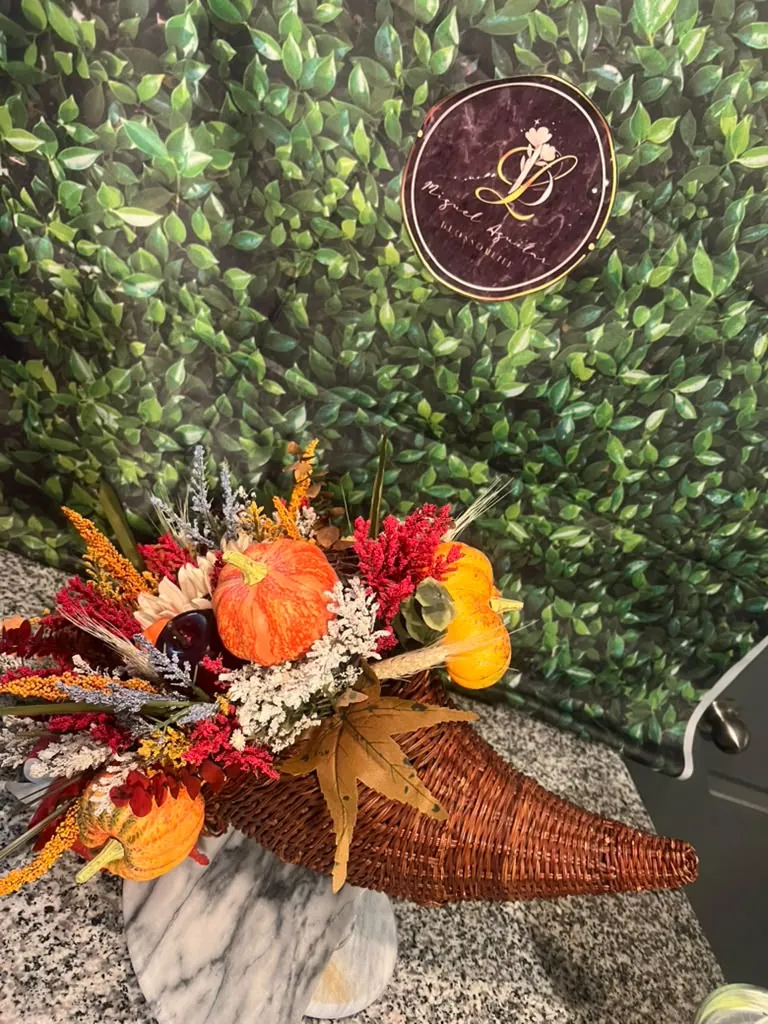 Fall entry table styled with pumpkins and orange florals