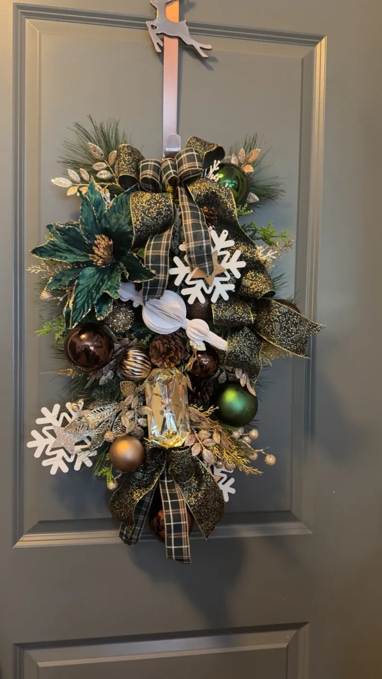 Christmas arrangement with a wooden deer and red velvet bow