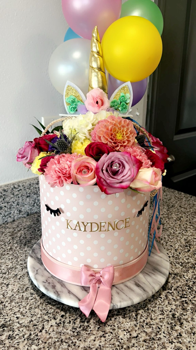 Pink flower gift arrangement with balloons