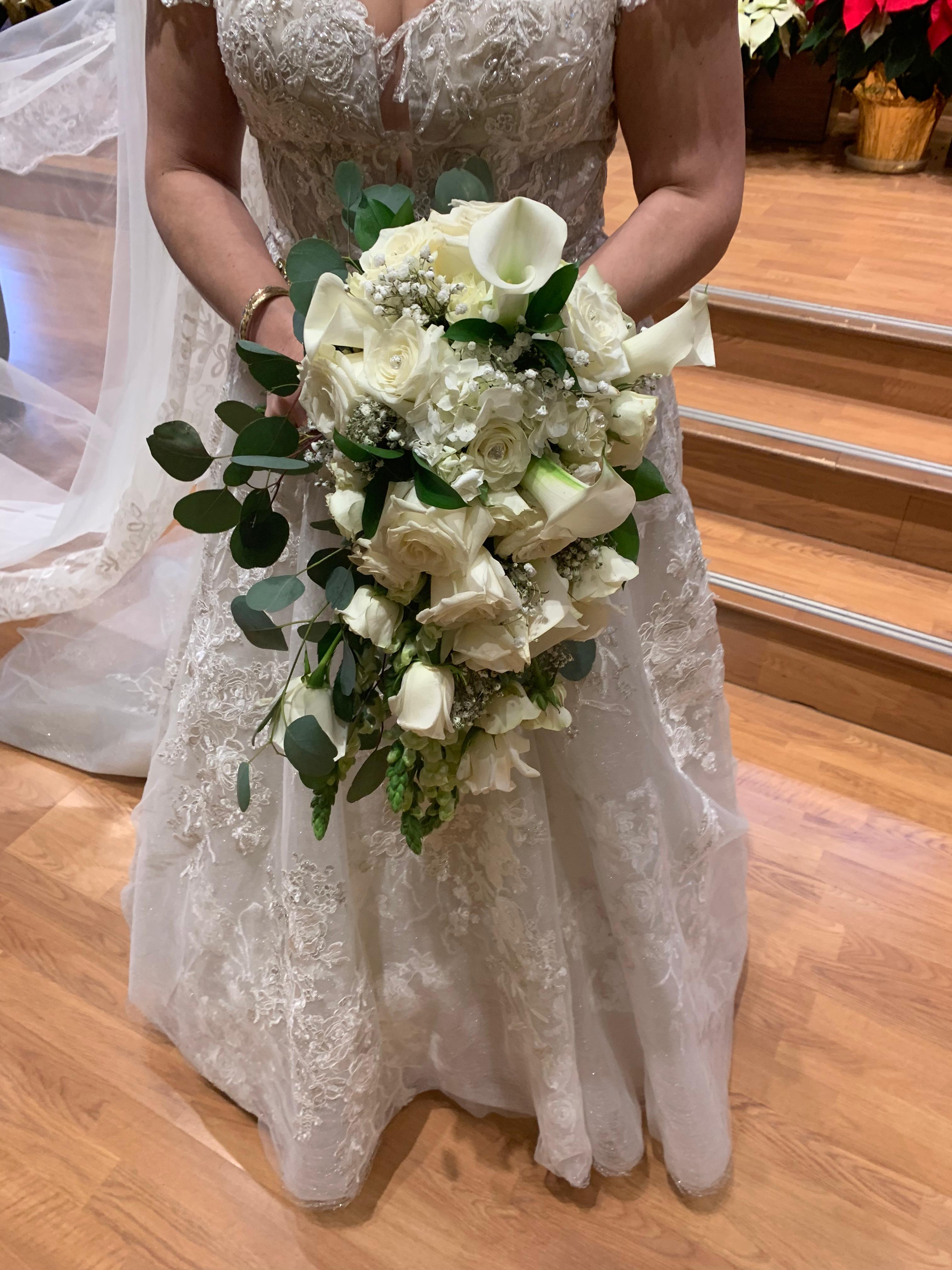 White bridal bouquet with roses, calla lilies, and eucalyptus
